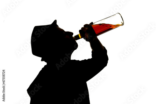 silhouette of alcoholic drunk man drinking whiskey bottle addict