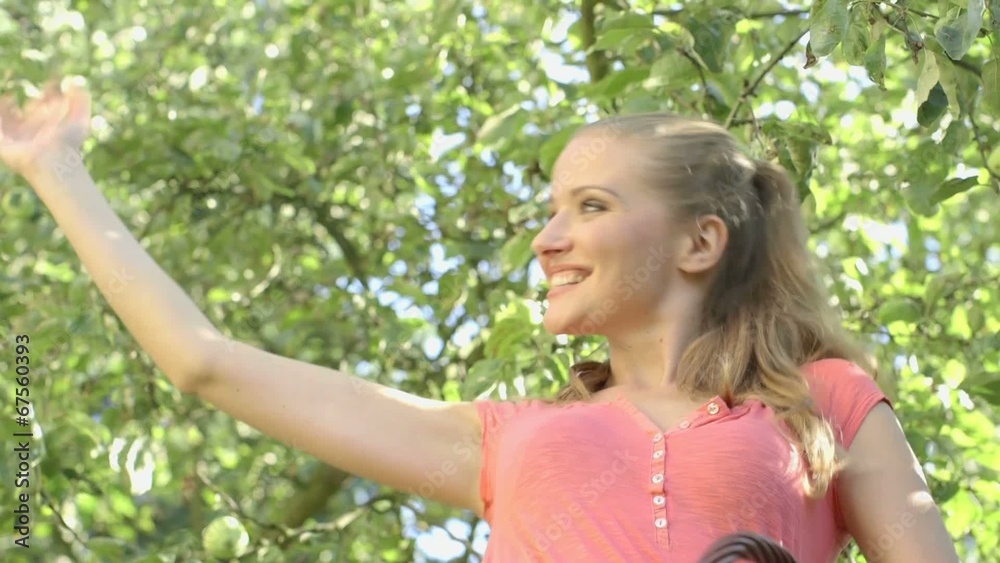 Blonde girl with wicker basket waving to friends. Blonde girl with wicker basket waving to friends.