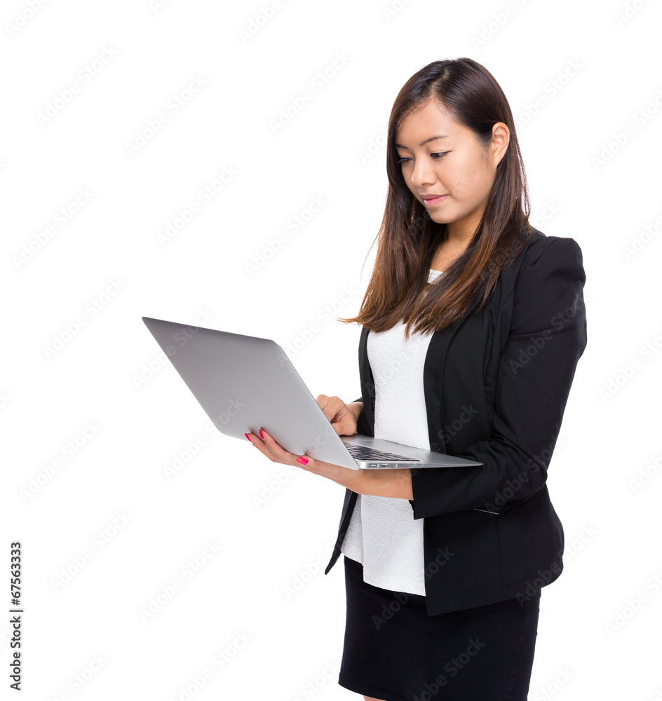 Asian business woman look at notebook computer Asian business woman look at notebook computer