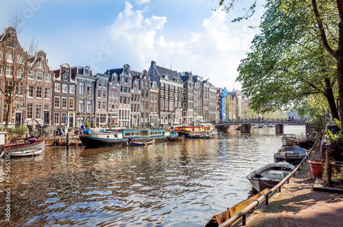 Photography Amsterdam canals with bridge and typical dutch houses.