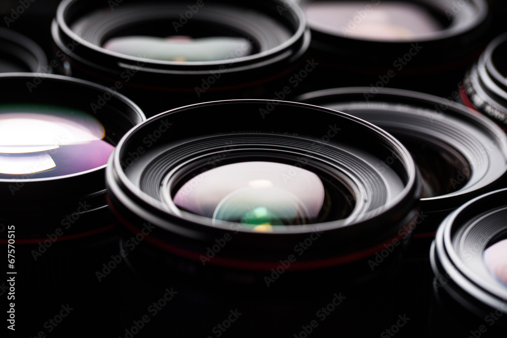 Modern camera lenses with reflections, low key image Modern camera lenses with reflections, low key image