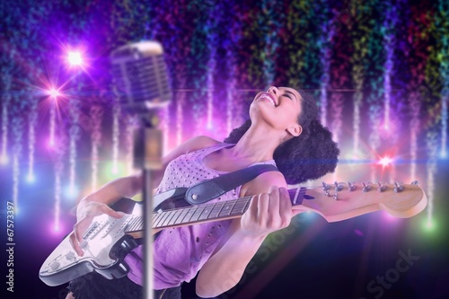 Composite image of pretty girl playing guitar