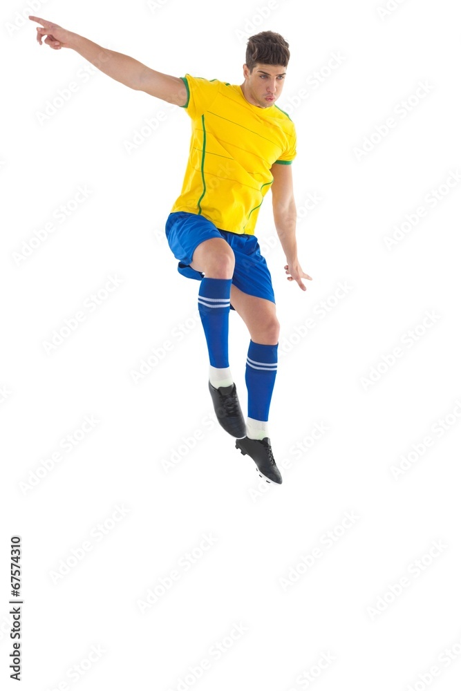 Football player in yellow kicking Football player in yellow kicking
