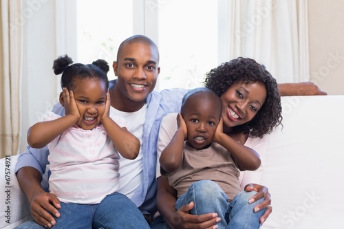 Happy family posing on the couch together