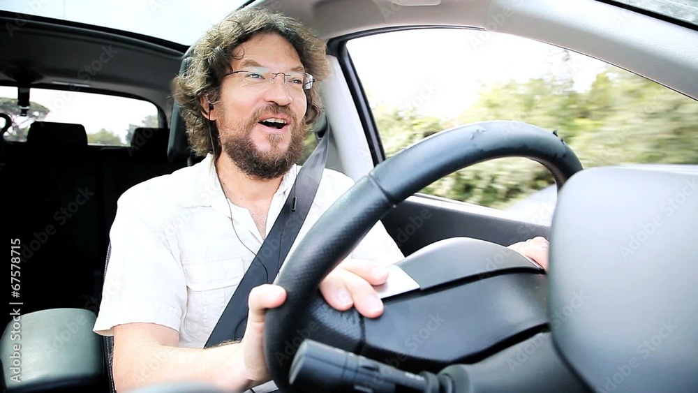 Happy man talking on the phone while driving Happy man talking on the phone while driving