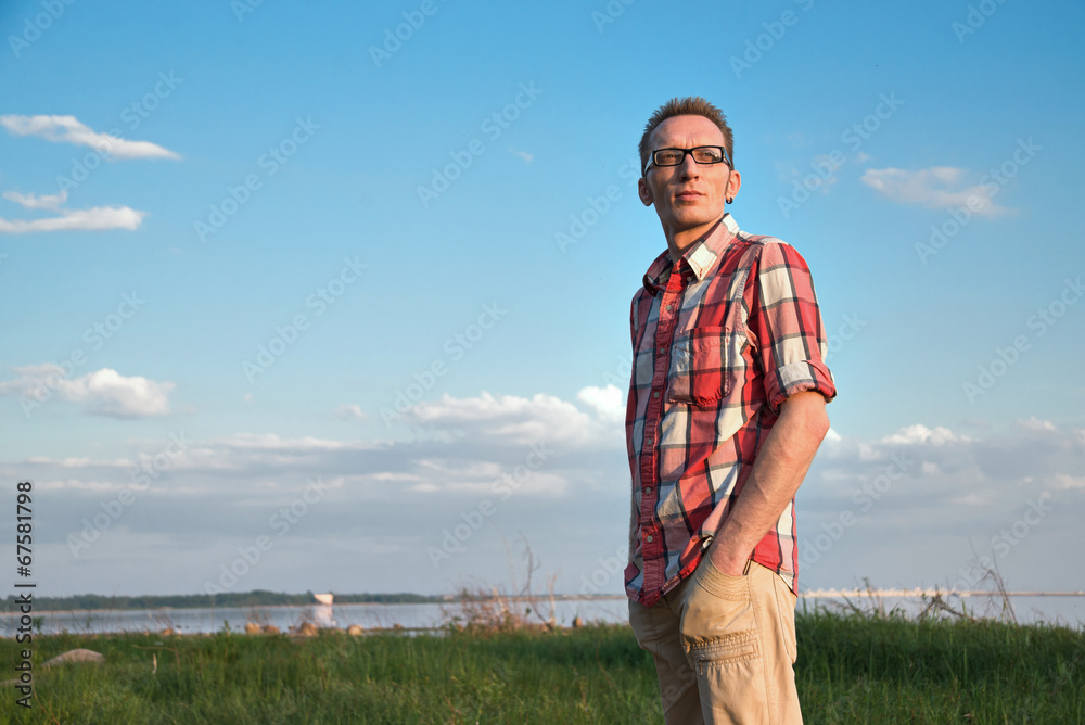 Confident smiling mature man looking at camera outdoor coast