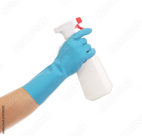 Hand in gloves holds spray bottle.