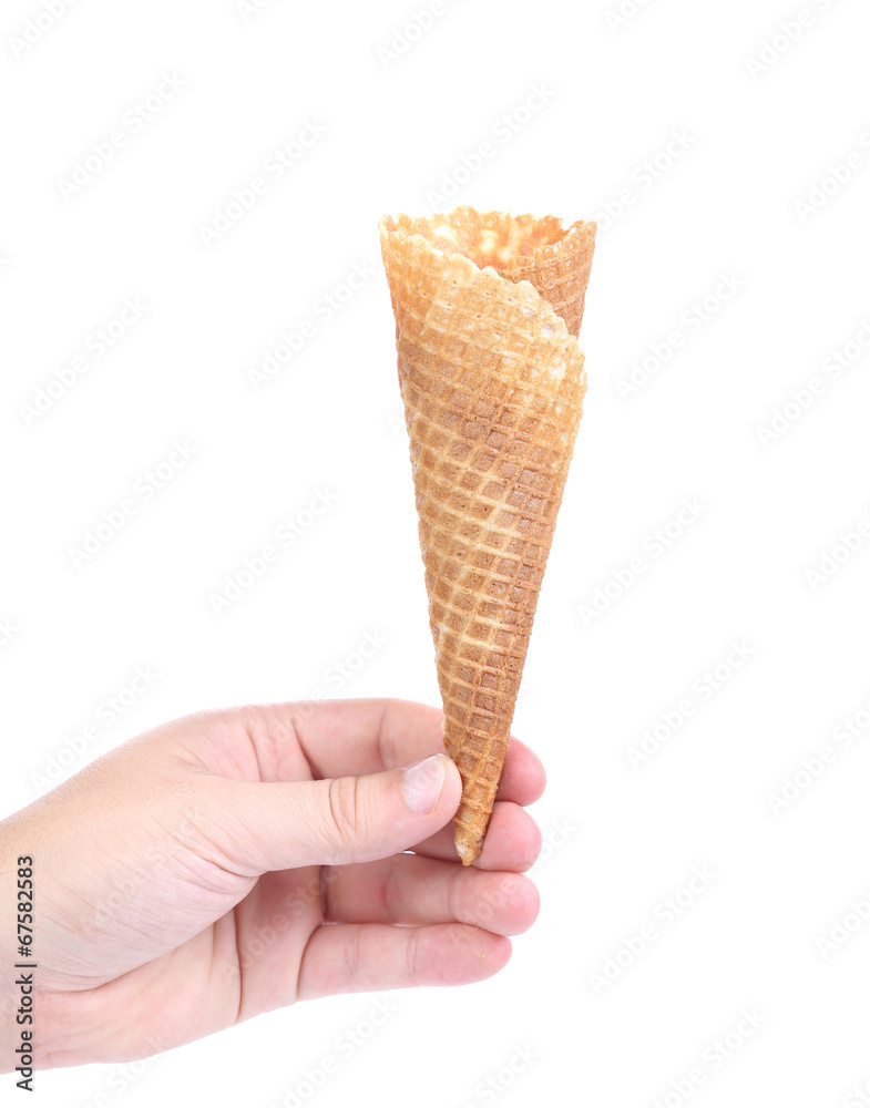 Hand holds empty ice cream corn. Hand holds empty ice cream corn.