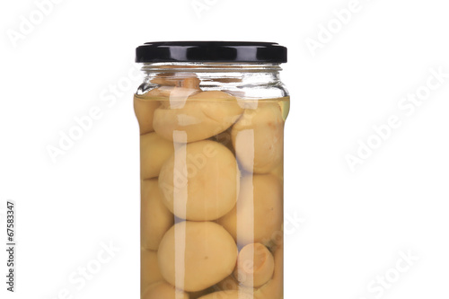 Marinated mushrooms in glass jar.