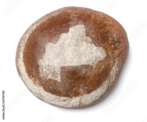 A loaf of fresh bread covered with rye flour in the shape of Bur