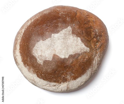 A loaf of fresh bread covered with rye flour in the shape of Cen