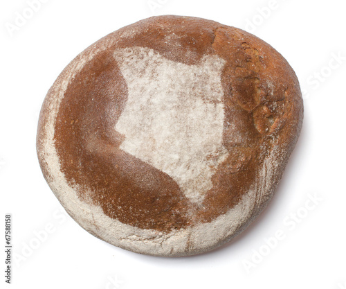 A loaf of fresh bread covered with rye flour in the shape of Ken