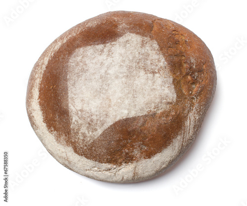 A loaf of fresh bread covered with rye flour in the shape of Rwa