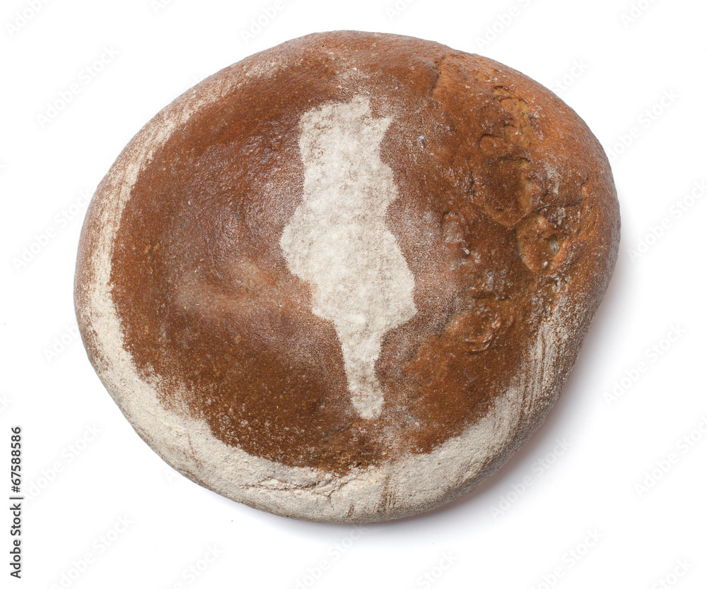 A loaf of fresh bread covered with rye flour in the shape of Tun A loaf of fresh bread covered with rye flour in the shape of Tun