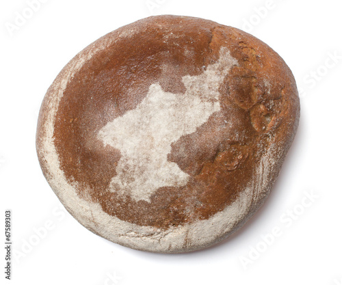 A loaf of fresh bread covered with rye flour in the shape of Nor