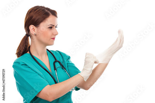 Attractive female doctor putting  sterilized surgical gloves