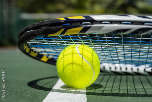 Close up view of tennis racket and balls on tennis court © gawriloff