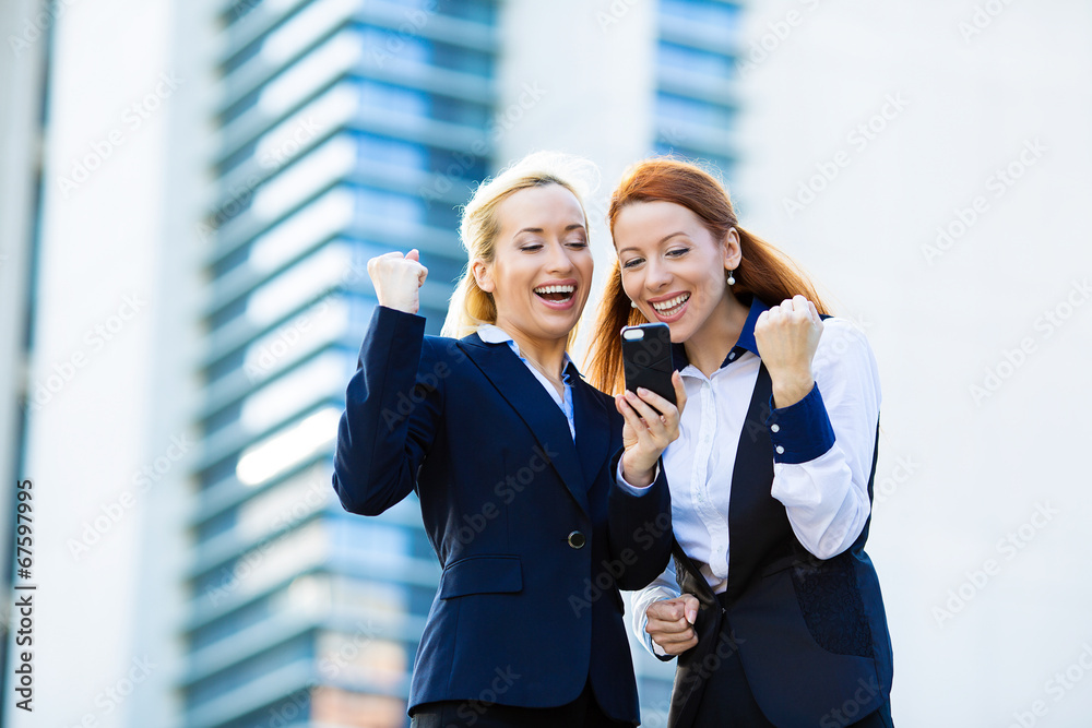Fototapeta premium Happy businesswomen celebrating success, corporate office