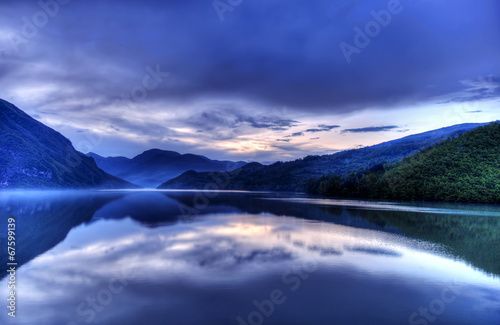 Clouds and mountains reflected in the lake