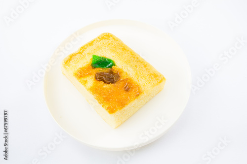 Sliced butter cake on white background