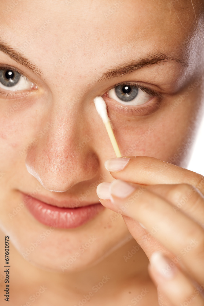beautiful young woman cleans her eye using cotton swab beautiful young woman cleans her eye using cotton swab