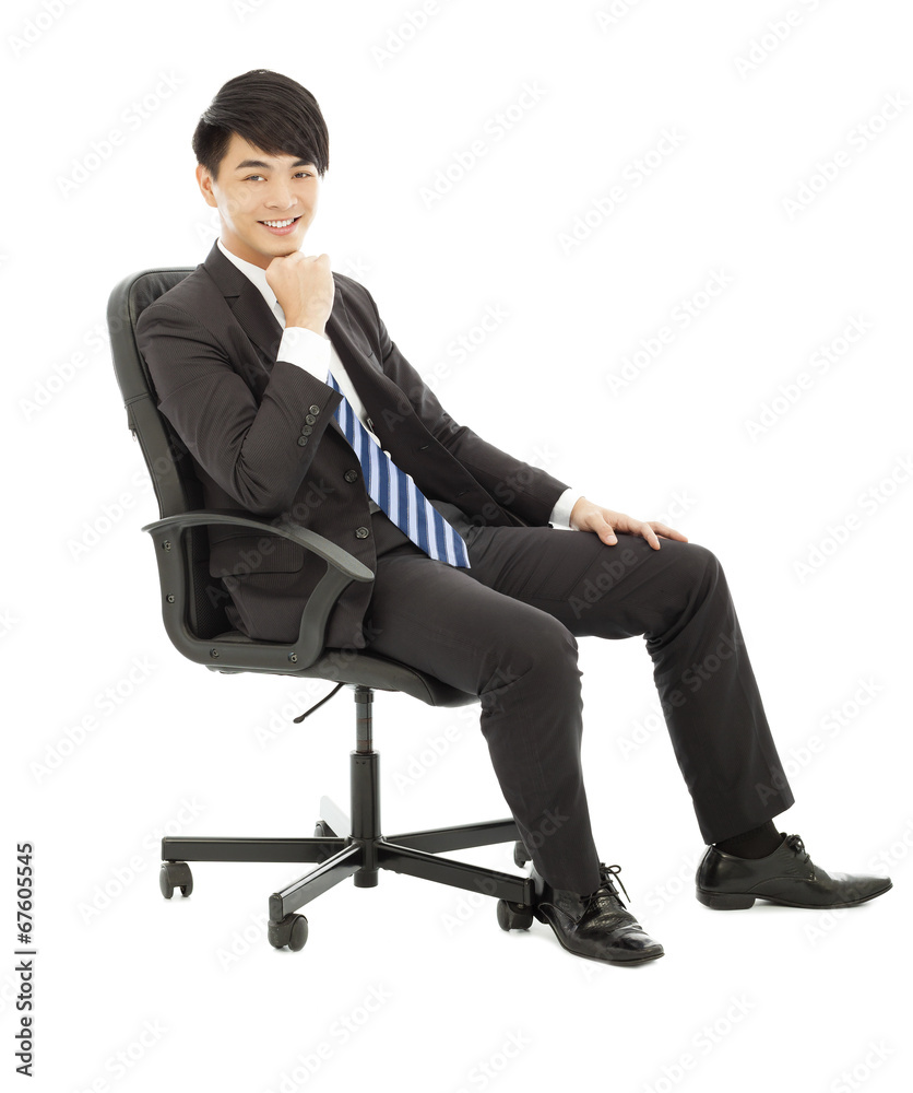 smiling Young business man sitting on a chair smiling Young business man sitting on a chair