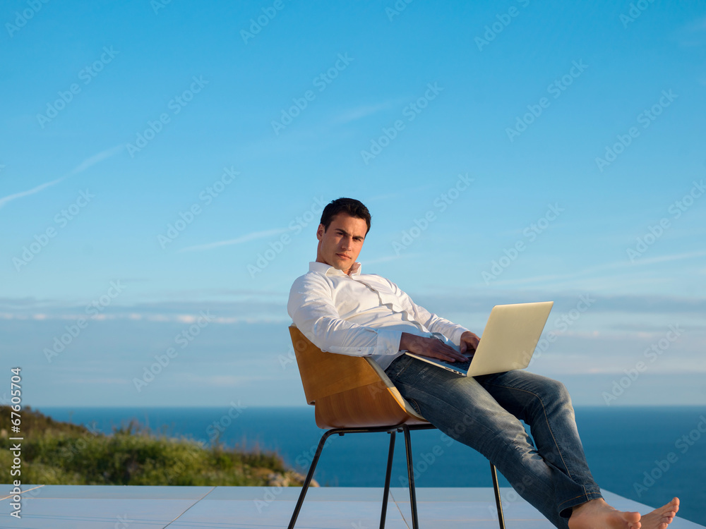 relaxed young man at home on balcony