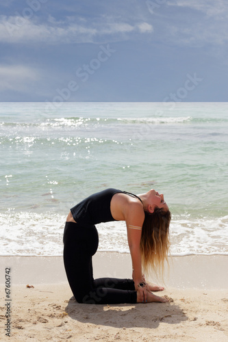 Stock image of ustrasana yoga pose on the beach photo