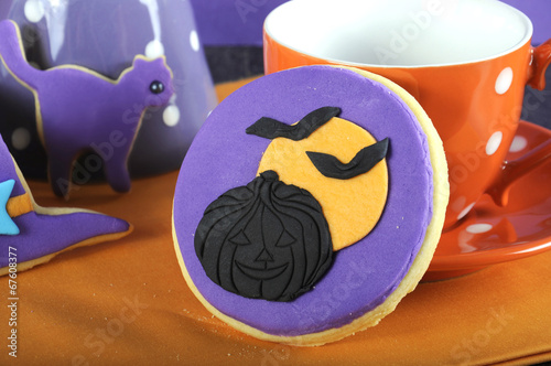 Happy Halloween trick or treat purple and orange cookie close up