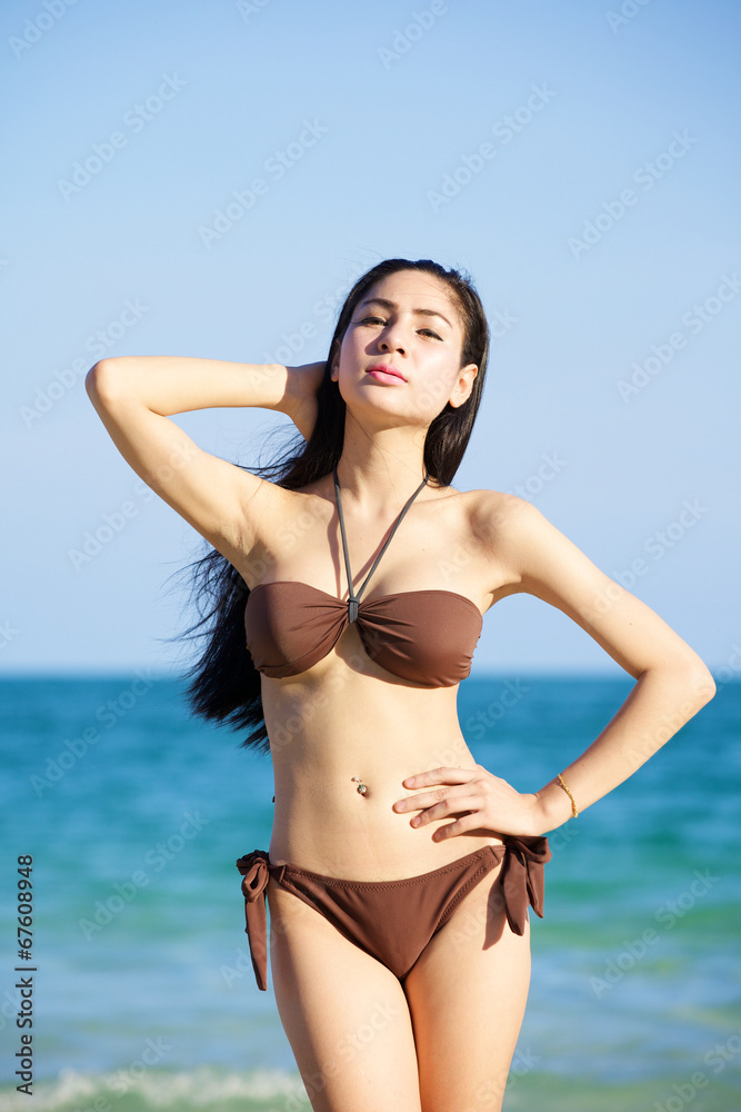 beautiful woman in bikini on the beach at summer day