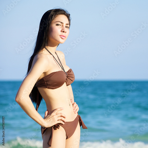beautiful woman in bikini on the beach at summer day