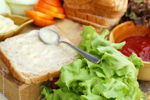 making tuna sandwich with fresh vegetables