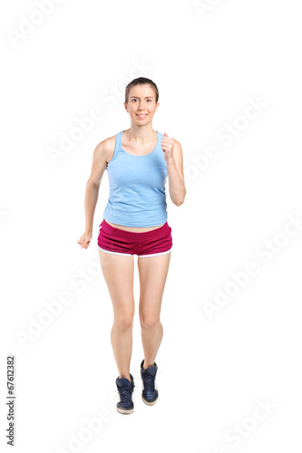 Full length portrait of a young woman jogging