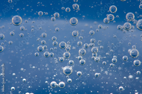 Air bubbles in a liquid. Abstract blue background. Macro