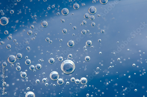Air bubbles in a liquid. Abstract blue background. Macro