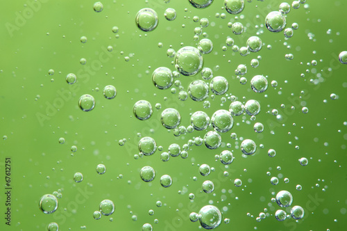 Air bubbles in a liquid. Abstract green background. Macro