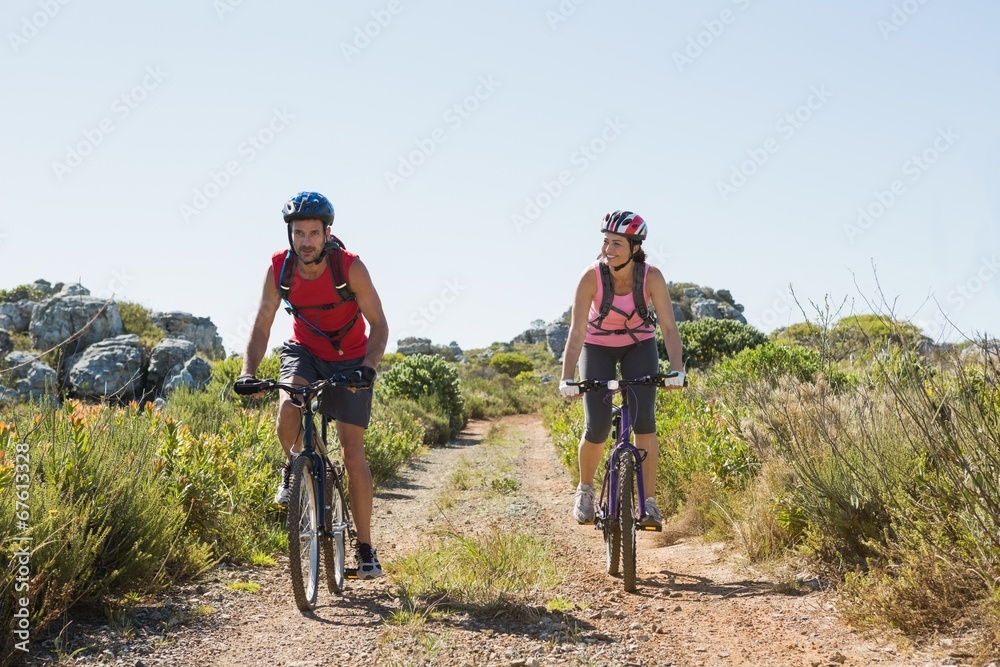 Active couple cycling in the countryside Active couple cycling in the countryside