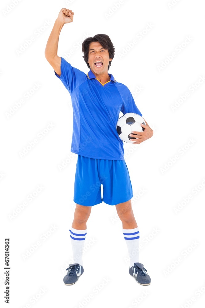Football player in blue celebrating a victory Football player in blue celebrating a victory