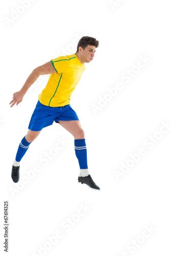 Football player in yellow jumping © WavebreakmediaMicro