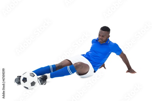 Football player in blue kicking © WavebreakmediaMicro