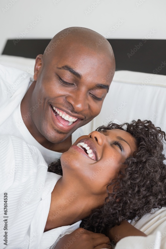 Fototapeta premium Happy couple lying in bed together