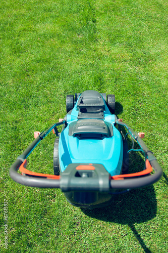 blue lawn mower on green grass