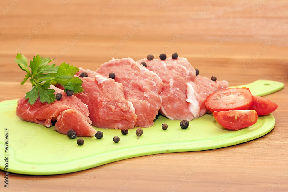 piece of raw meat with spices and vegetables piece of raw meat with spices and vegetables