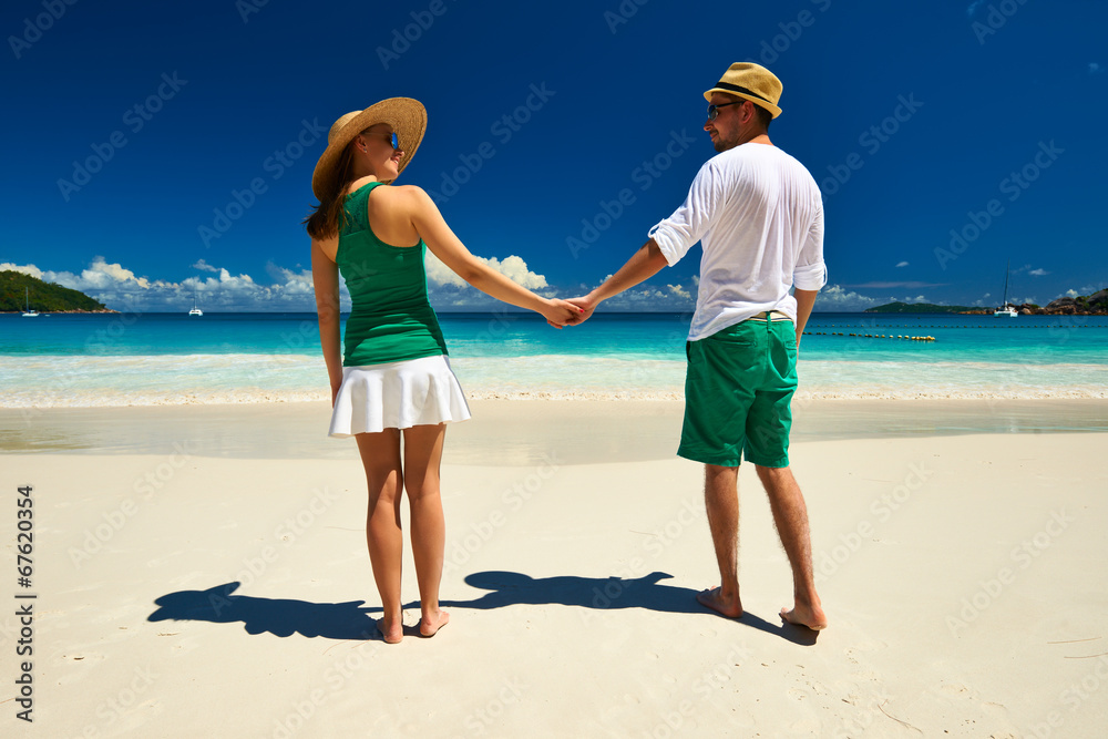 Couple in green on a beach at Seychelles Couple in green on a beach at Seychelles