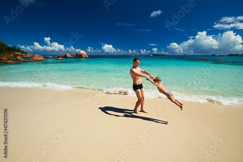 Father and two year old boy playing on beach