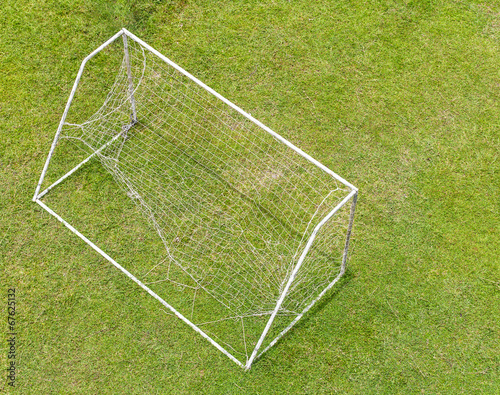 Above the lawn with old soccer goal nets tear from use