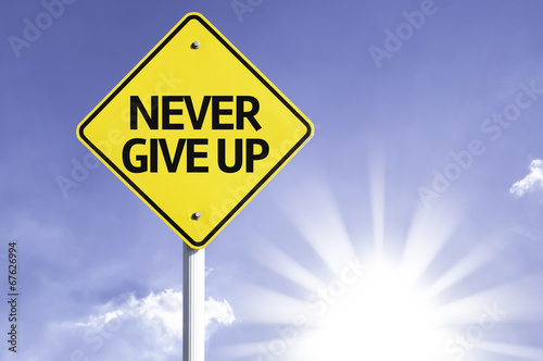 Never Give Up road sign with sun background