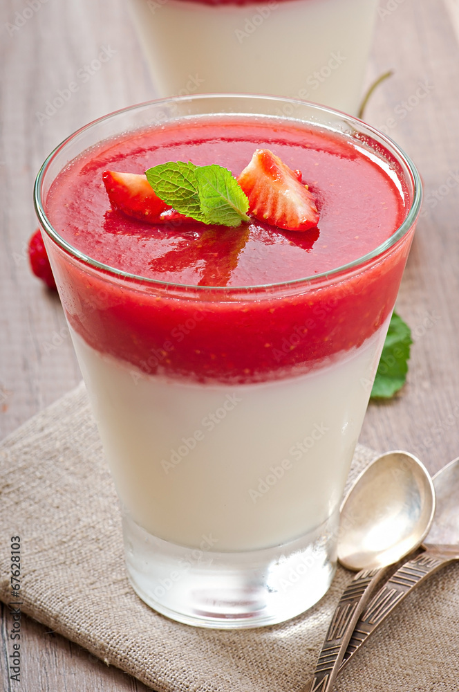 Dessert Panna Cotta with fresh strawberry on old wooden backgrou Dessert Panna Cotta with fresh strawberry on old wooden backgrou