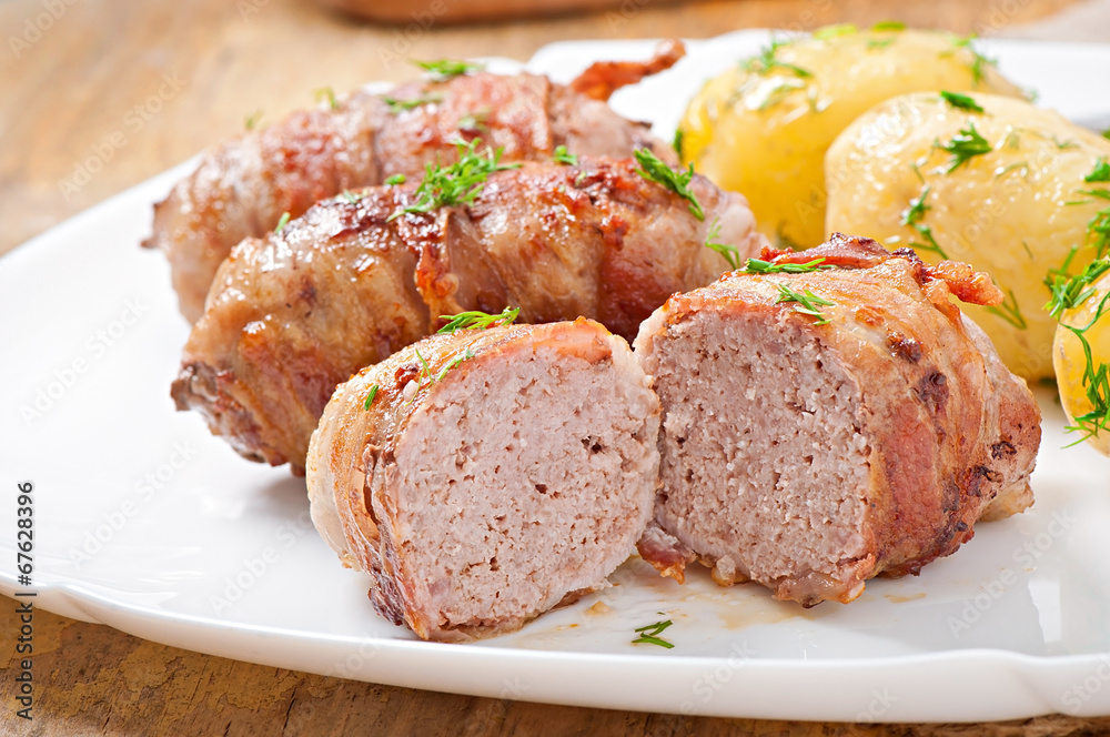 Grilled meat rolls wrapped in strips of bacon Grilled meat rolls wrapped in strips of bacon
