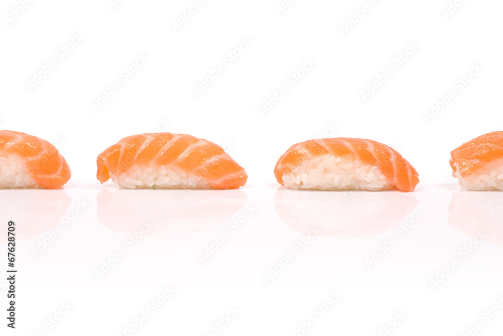 Four Sushi with Salmon in line with reflection isolated on white